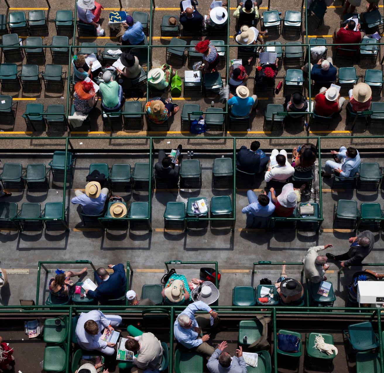 Overhead shot of people sitting in chairs at a derby.