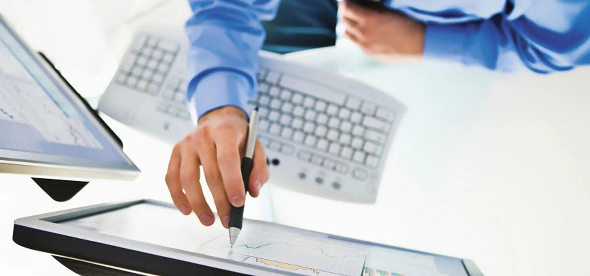 Overhead view of a person pressing a screen