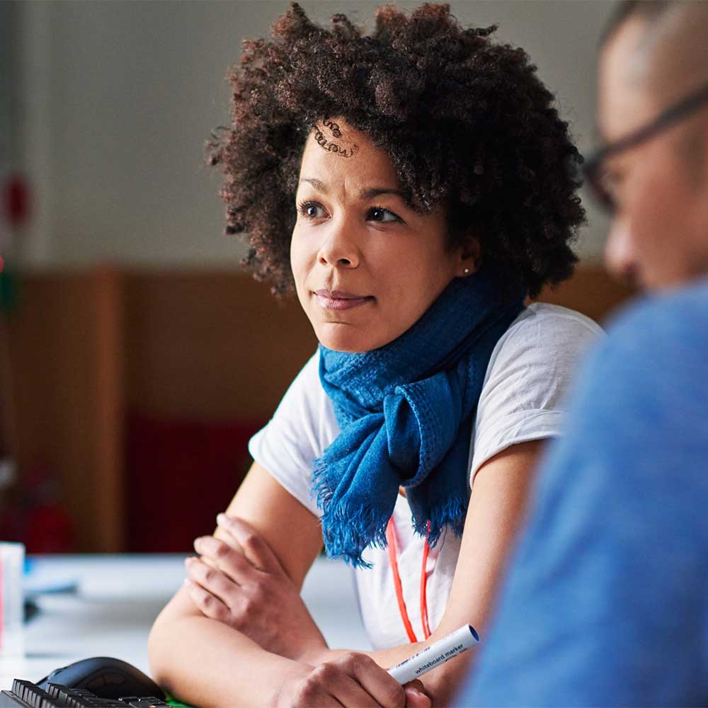 Female and male working together in front of computer
