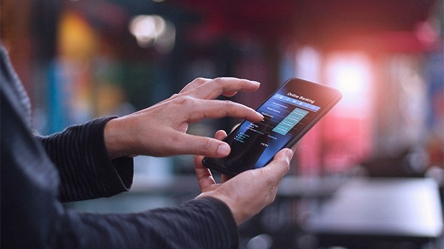 Hands holding and swiping on phone