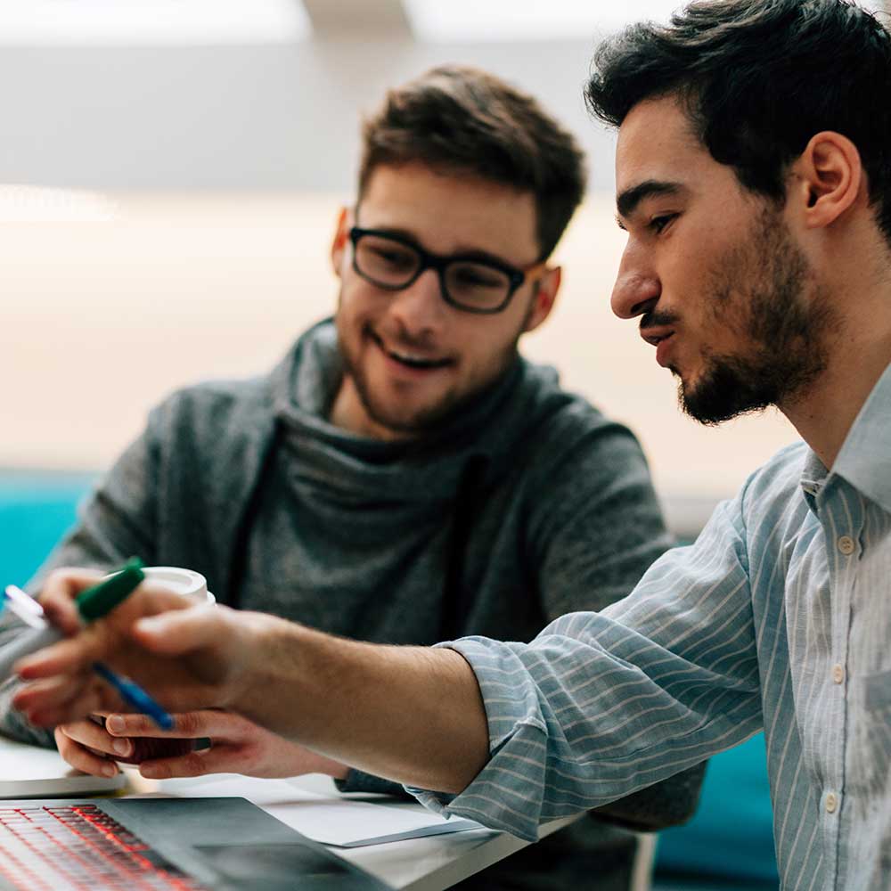 Two coworkers collaborating at a computer