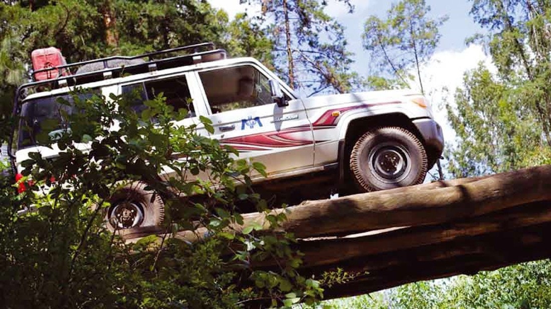 International Medicak Corp off road vehicle driving through jungle