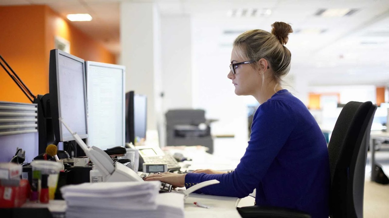 Woman at desk working on computer