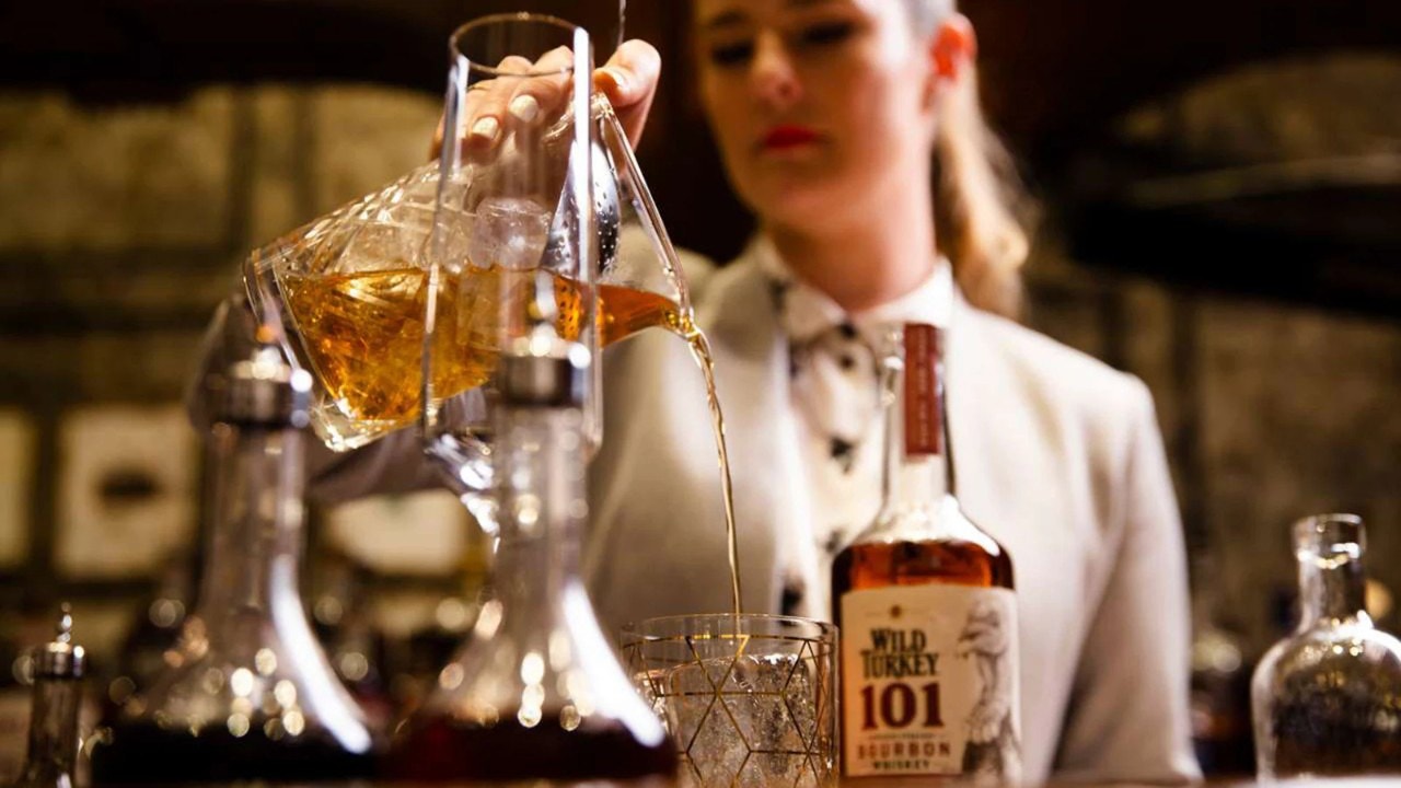 Woman bartender pouring drinks