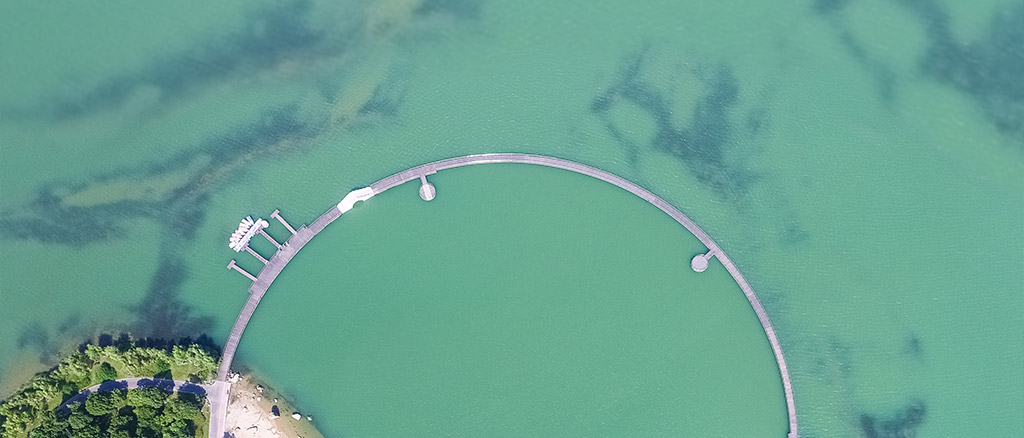 Aerial View of a Circular Lake Pedestrians in a lake