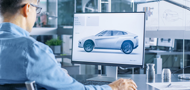 Engineer working on automotive design showing on monitor