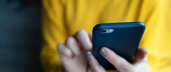 Close-up on woman hands using smartphone