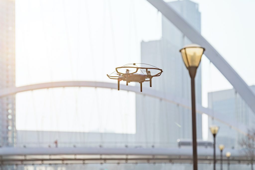 A drone flies in a city on a 5G connection