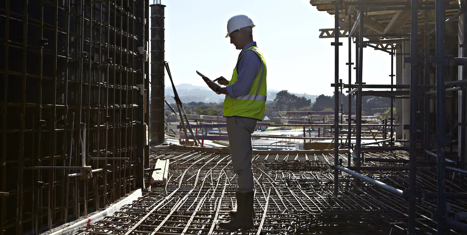 Architect using tablet computer on building site