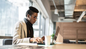 SAP Consultant Skills - African American woman sitting at a desk in office environment