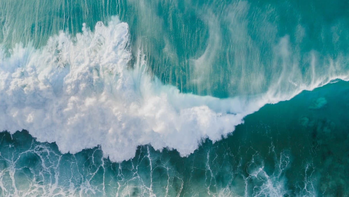 aerial view of waves breaking on shore