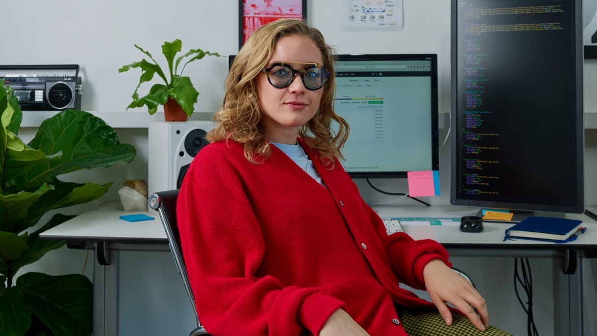Person in chair turned away from the desk and computer