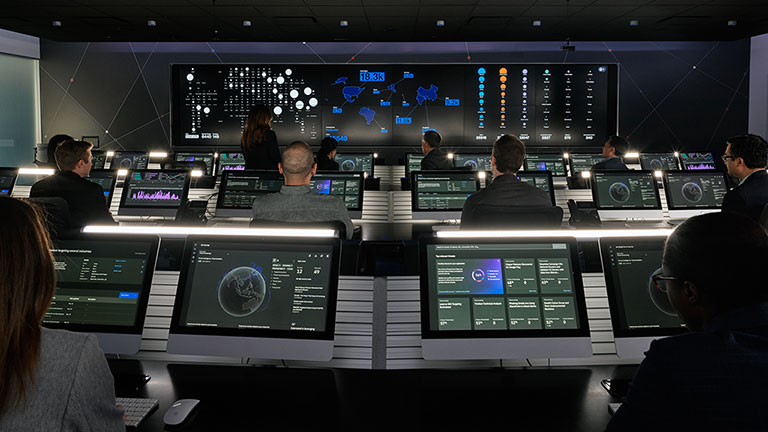 A control room with multiple people working at work stations.