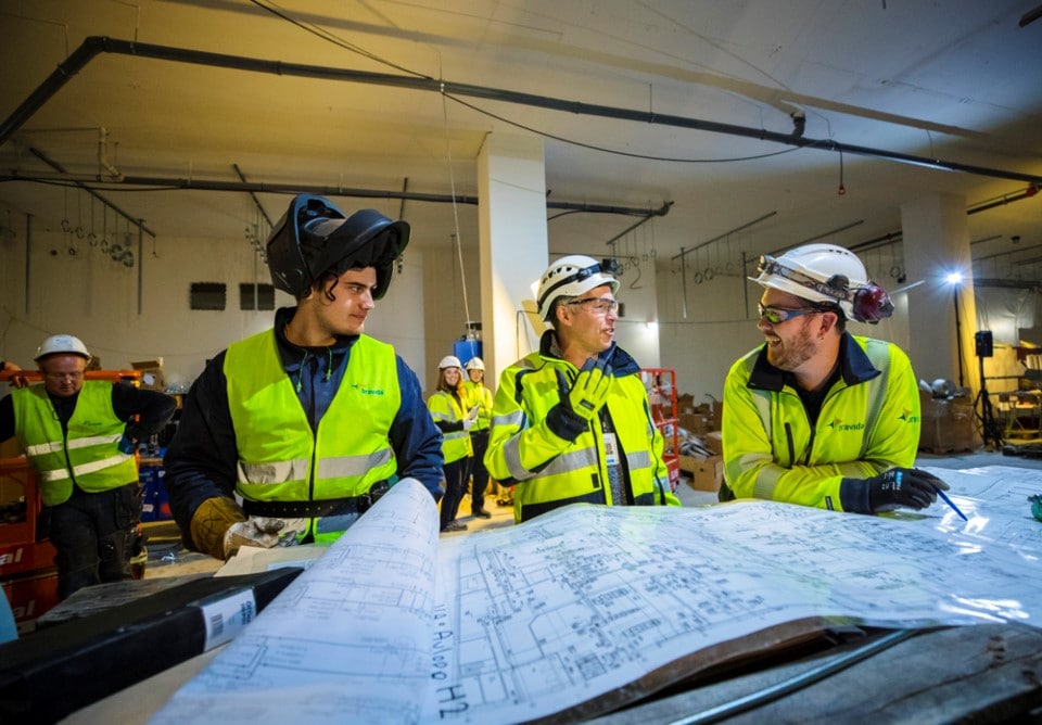 Engineers in safety gear discussing project