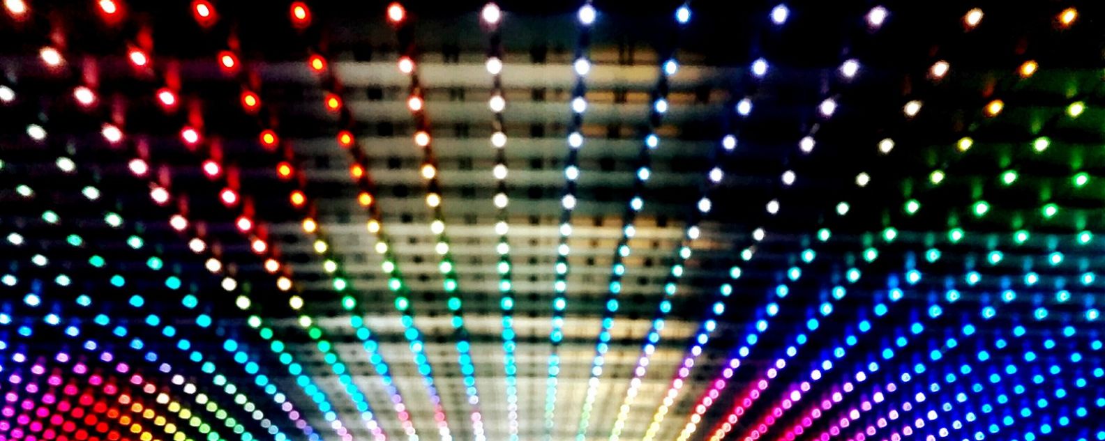 electronic abstract image of colorful lights across a ceiling