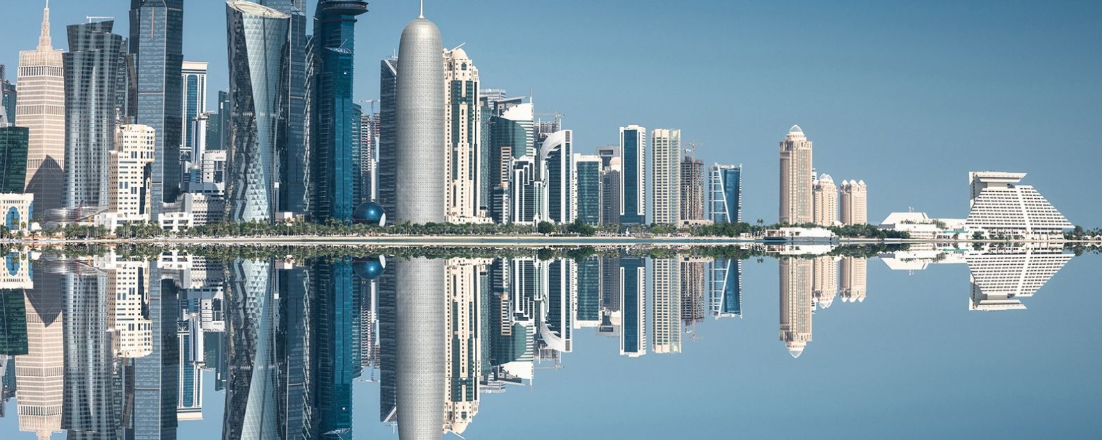 A city skyline image reflecting in the sea