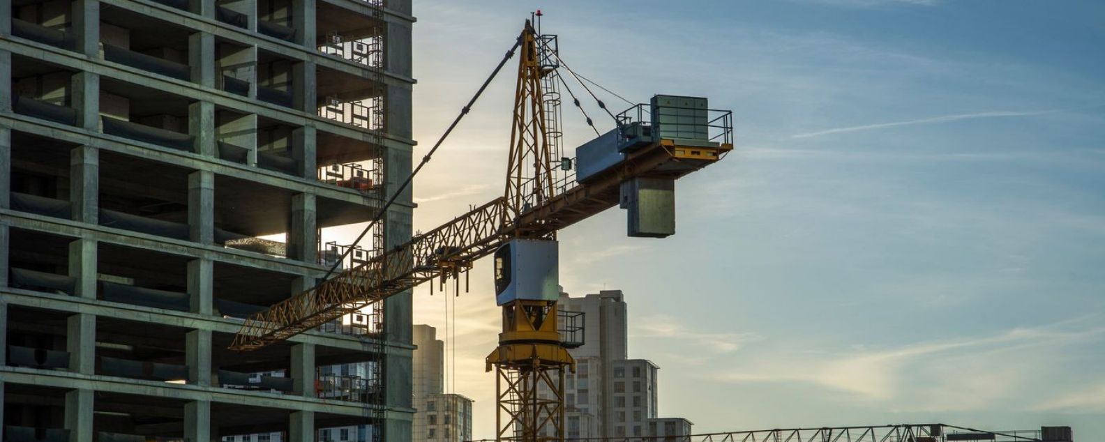 Top half of construction crane against a building