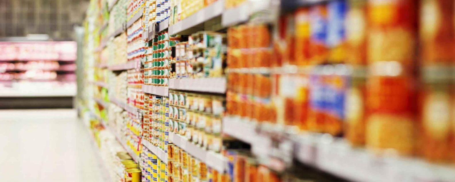 Blurred line of canned goods on grocery aisle