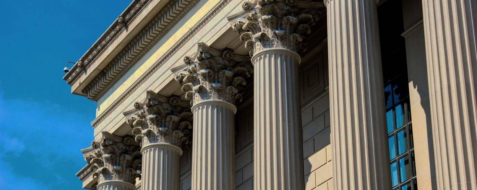 Close-up of building showing tops of corinthian columns