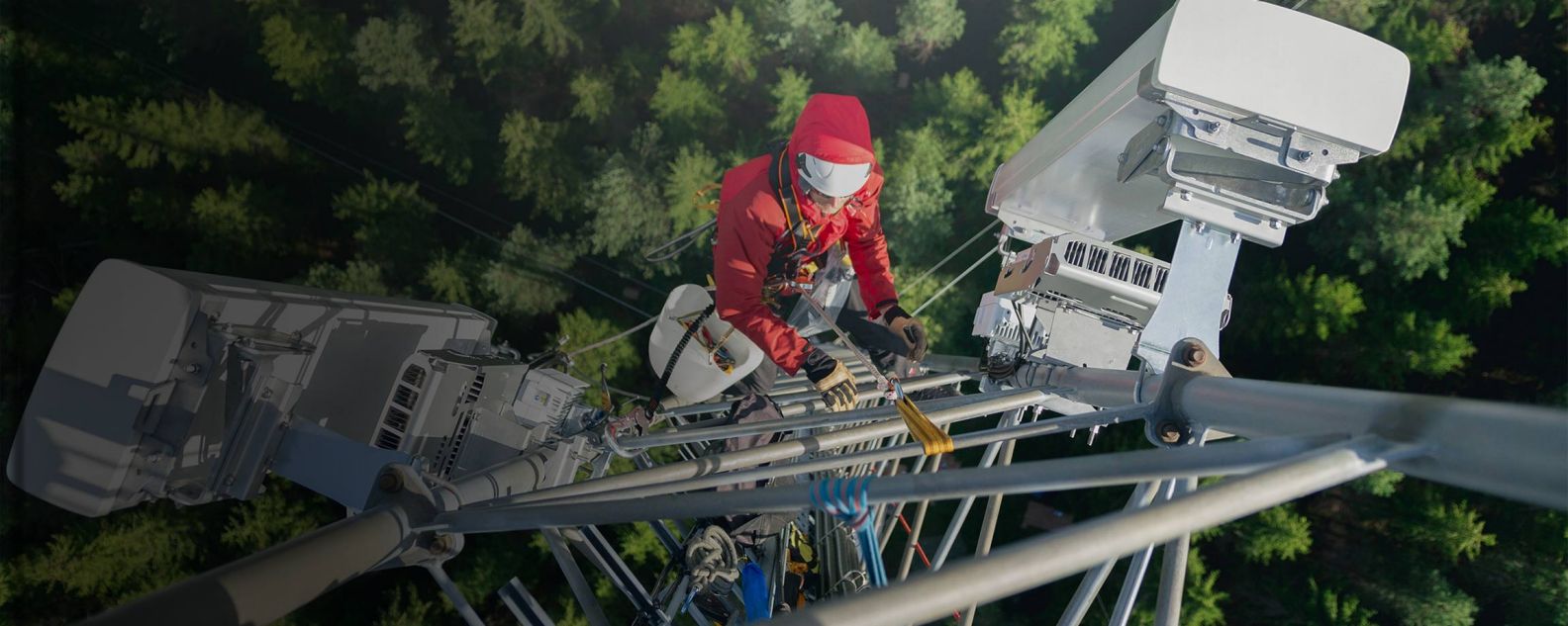 Telecommunication engineer, working at height, installing a new antenna on a communication tower