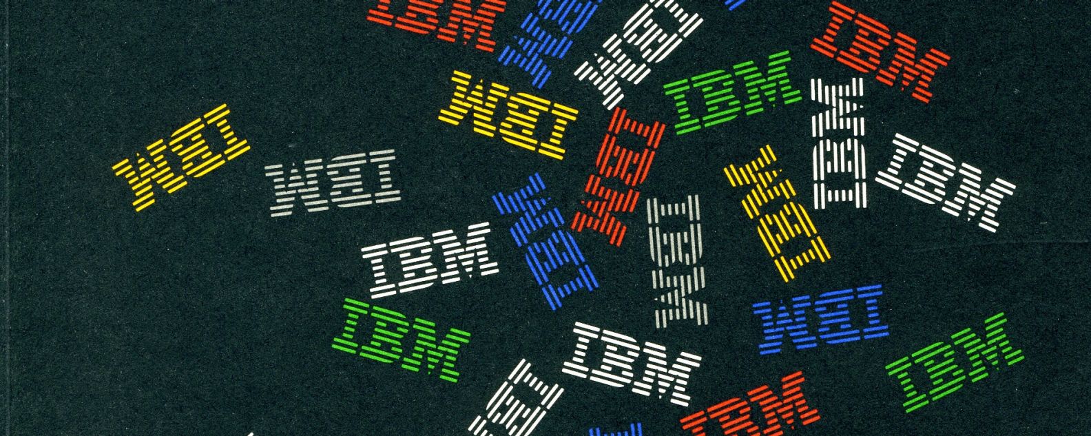 Multiples of the IBM 8-bar logo in various colors at various angles, against a black backdrop, design by Paul Rand