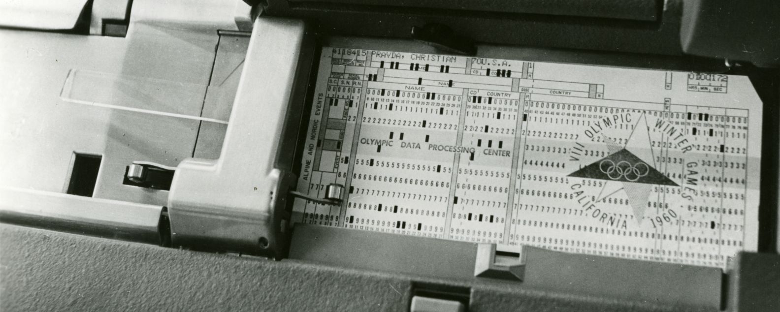Close-up of a punched card with an Olympic logo on it, and the words VIII Olympic Winter Games, California 1960