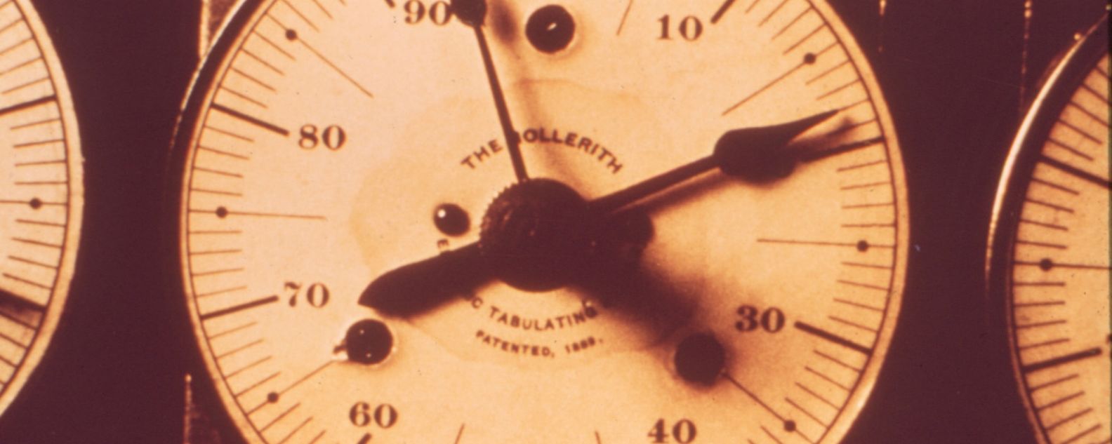 Close-up of a tabulating machine dial with a face showing zero to 99.