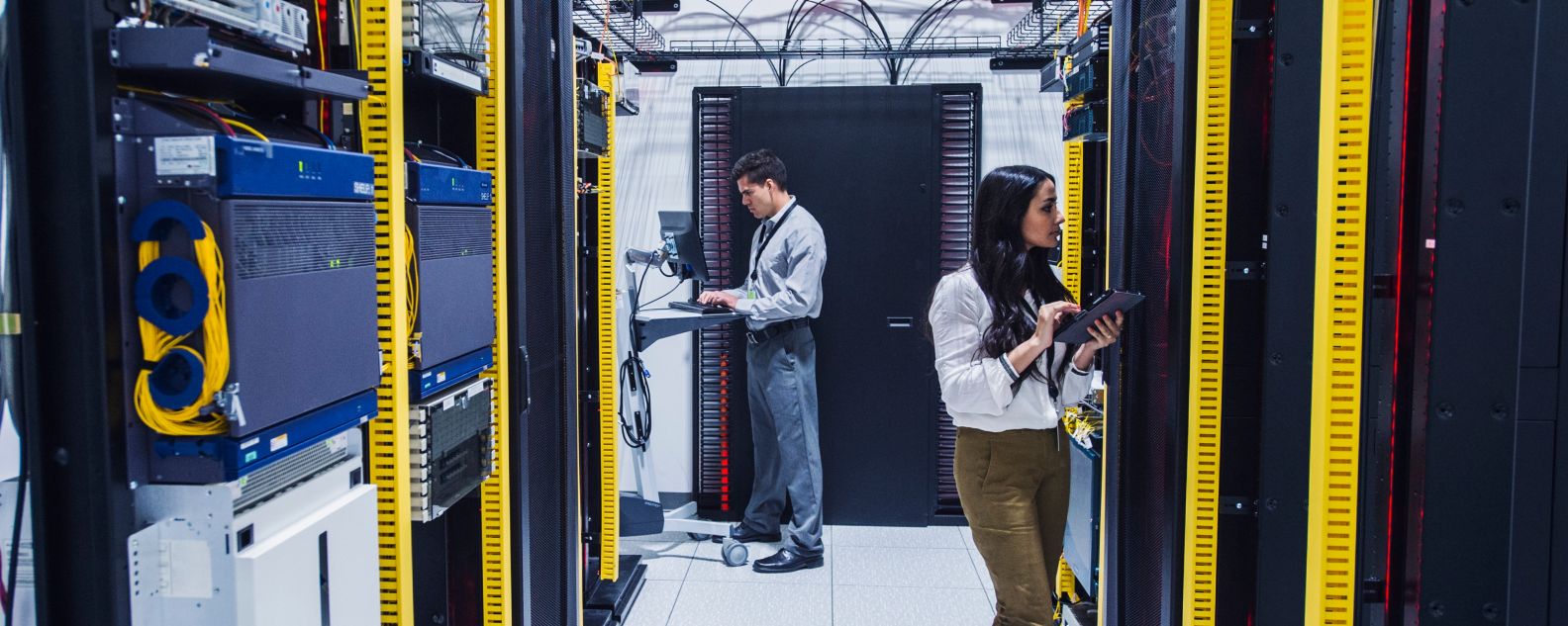 Two people working in a data center