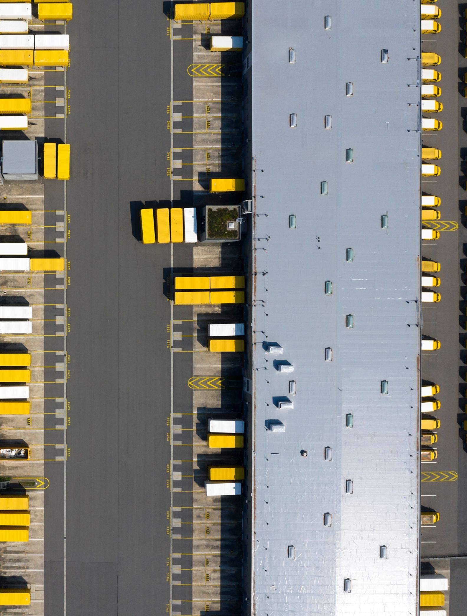 Aerial view of tractor trailers docked  at shipping facility