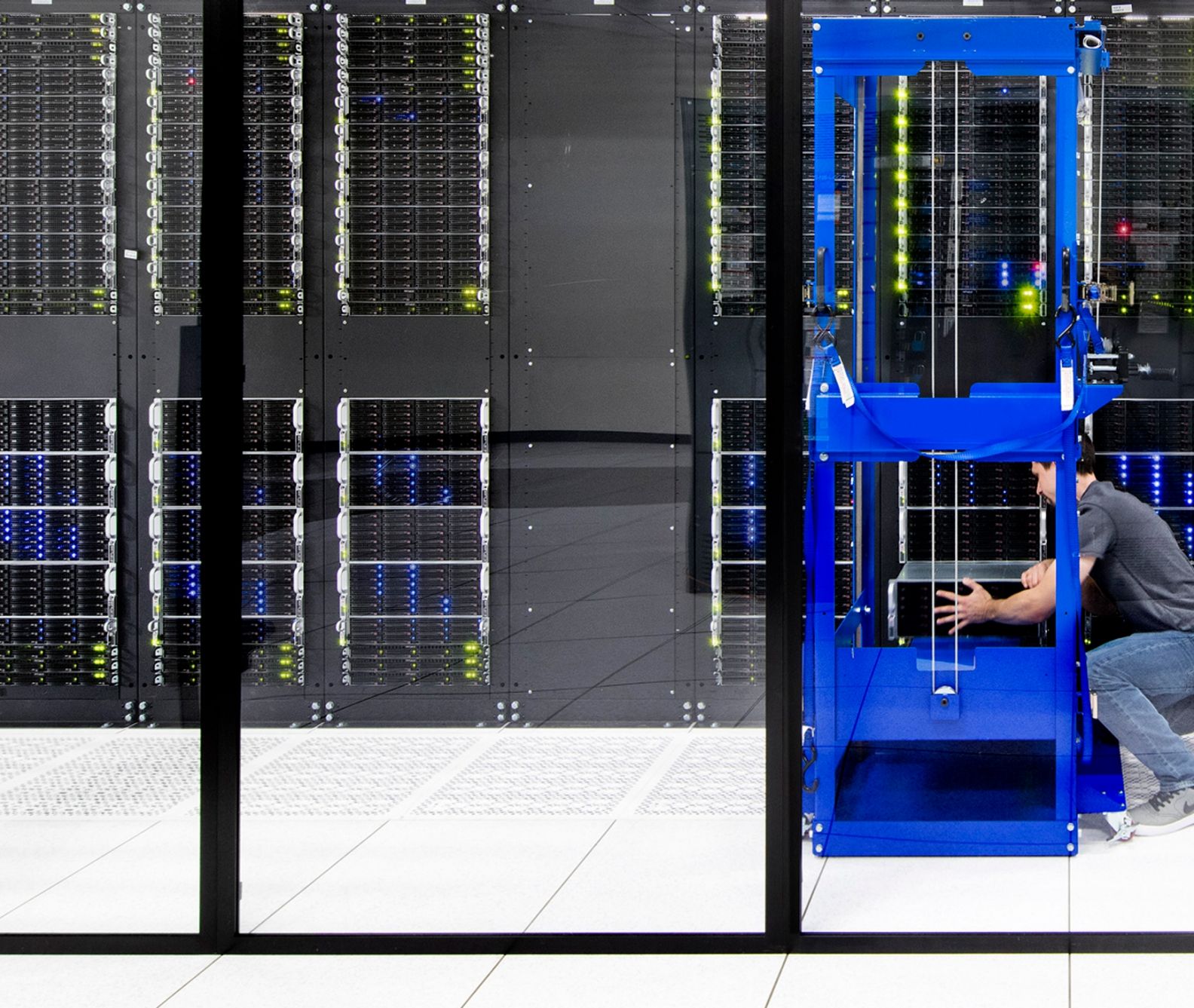 Man installing a server on a on cloud server bank
