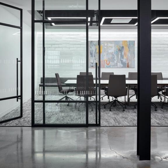 polished concrete floor outside of carpeted meeting room