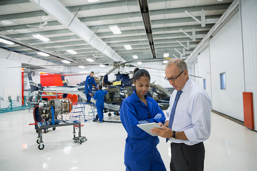 Engineers working on an helicopter engine