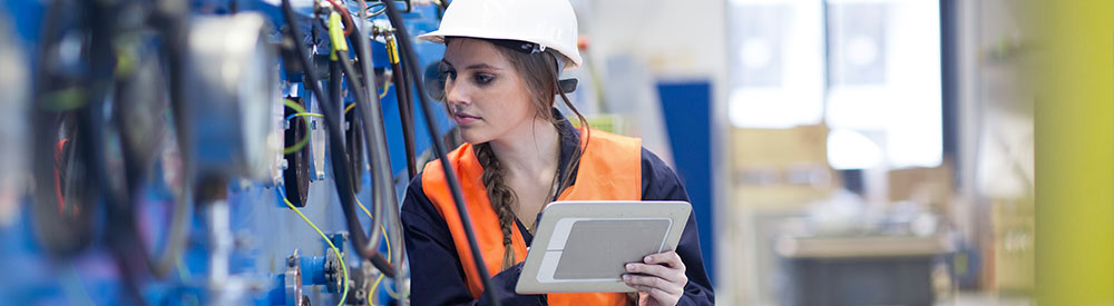 Maintenance technician using tablet to check equipment