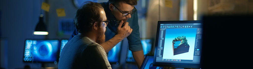 Men looking at engineering design on computer screen