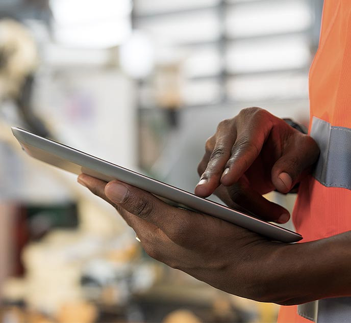 Closeup of mobile field service technician using tablet