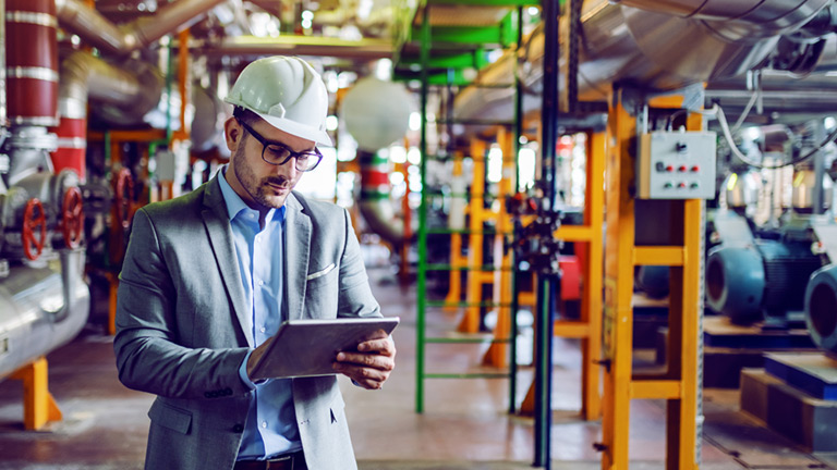 Person using tablet device at industry environment