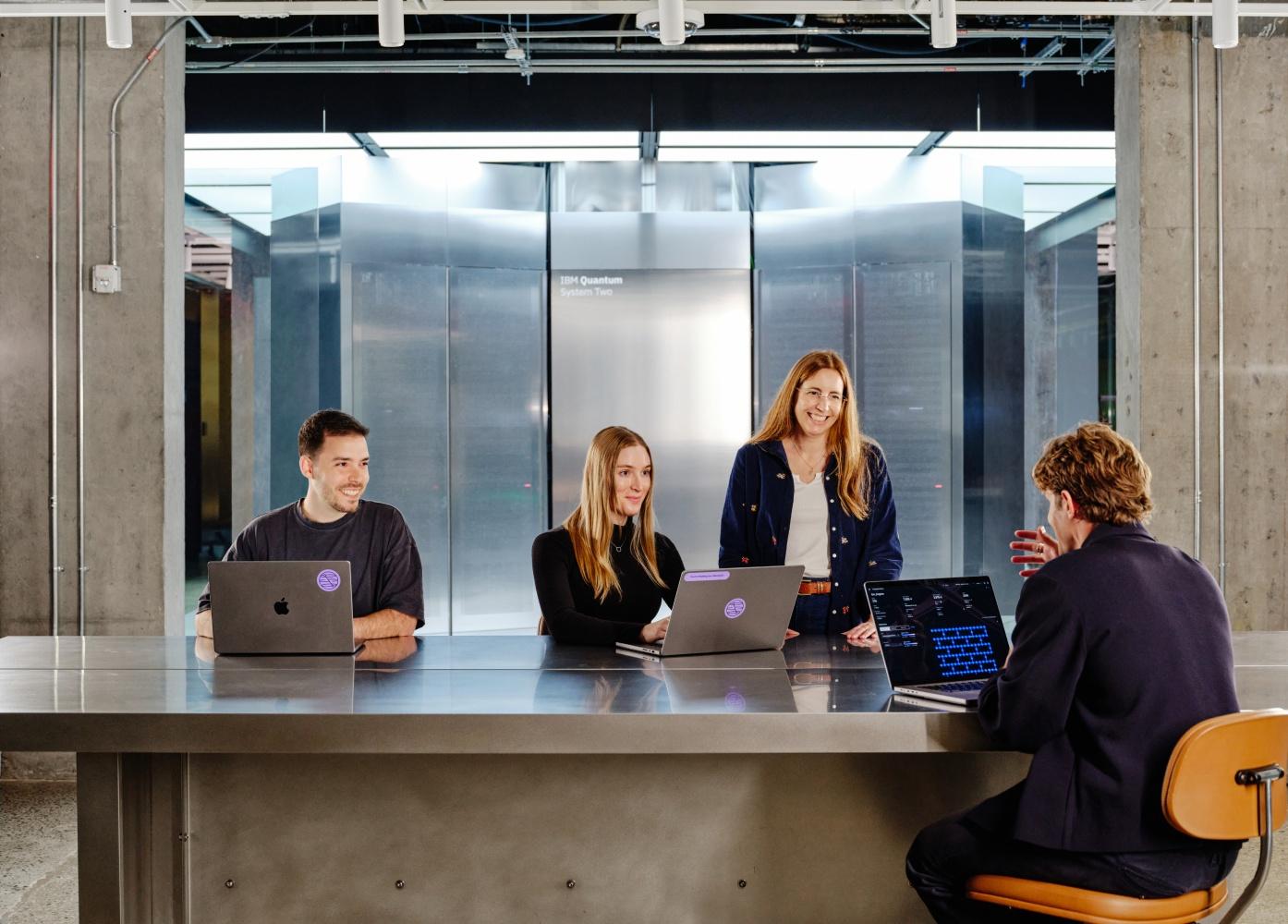 A photo of a group of people working at a table
