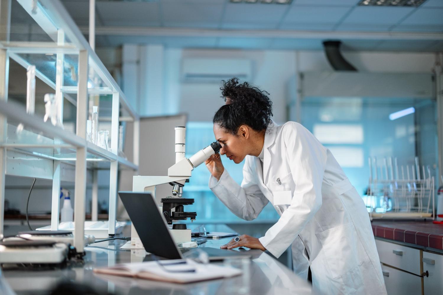 A photo of a researcher looking into a microscope