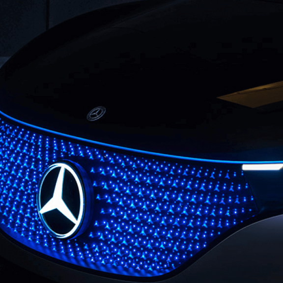 Close up of an illuminated Mercedes-Benz vehicle grill.