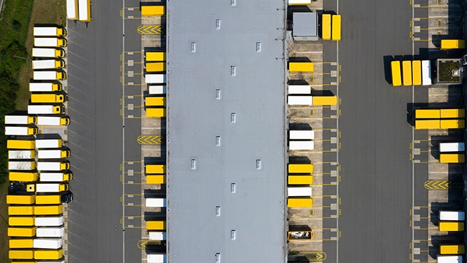 Aerial view of cargo containers and a distribution warehouse