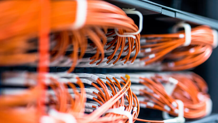 Close-up of orange high-speed networking cables connected to server components