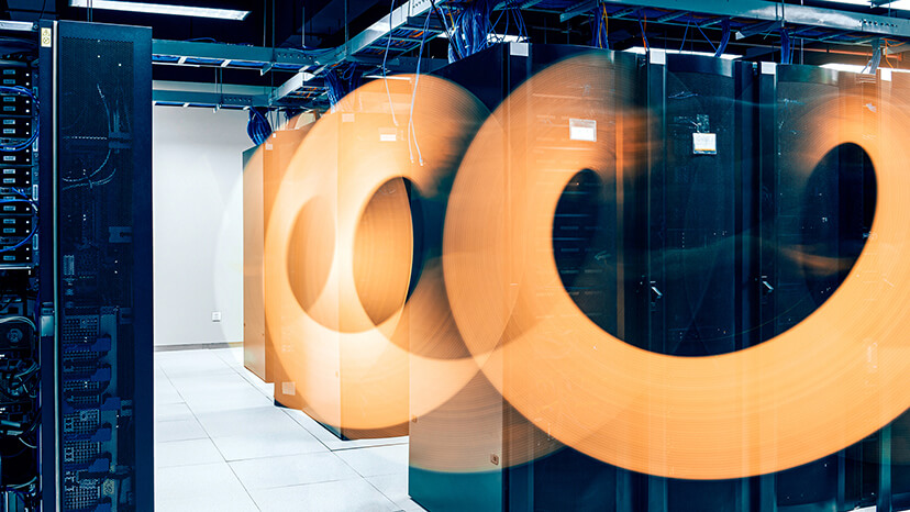 Time-lapse photography creates an interesting bright orange circular effect in a server storage room