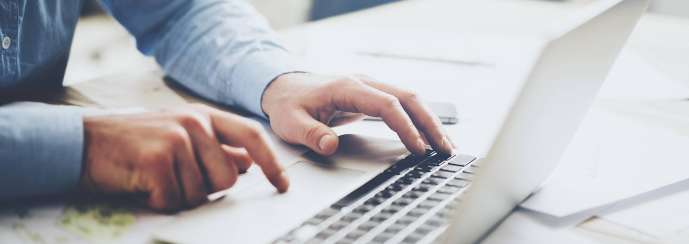 Person typing and holding card