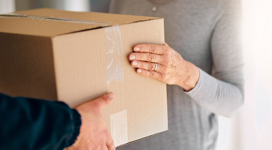 Woman receives a package from delivery service.